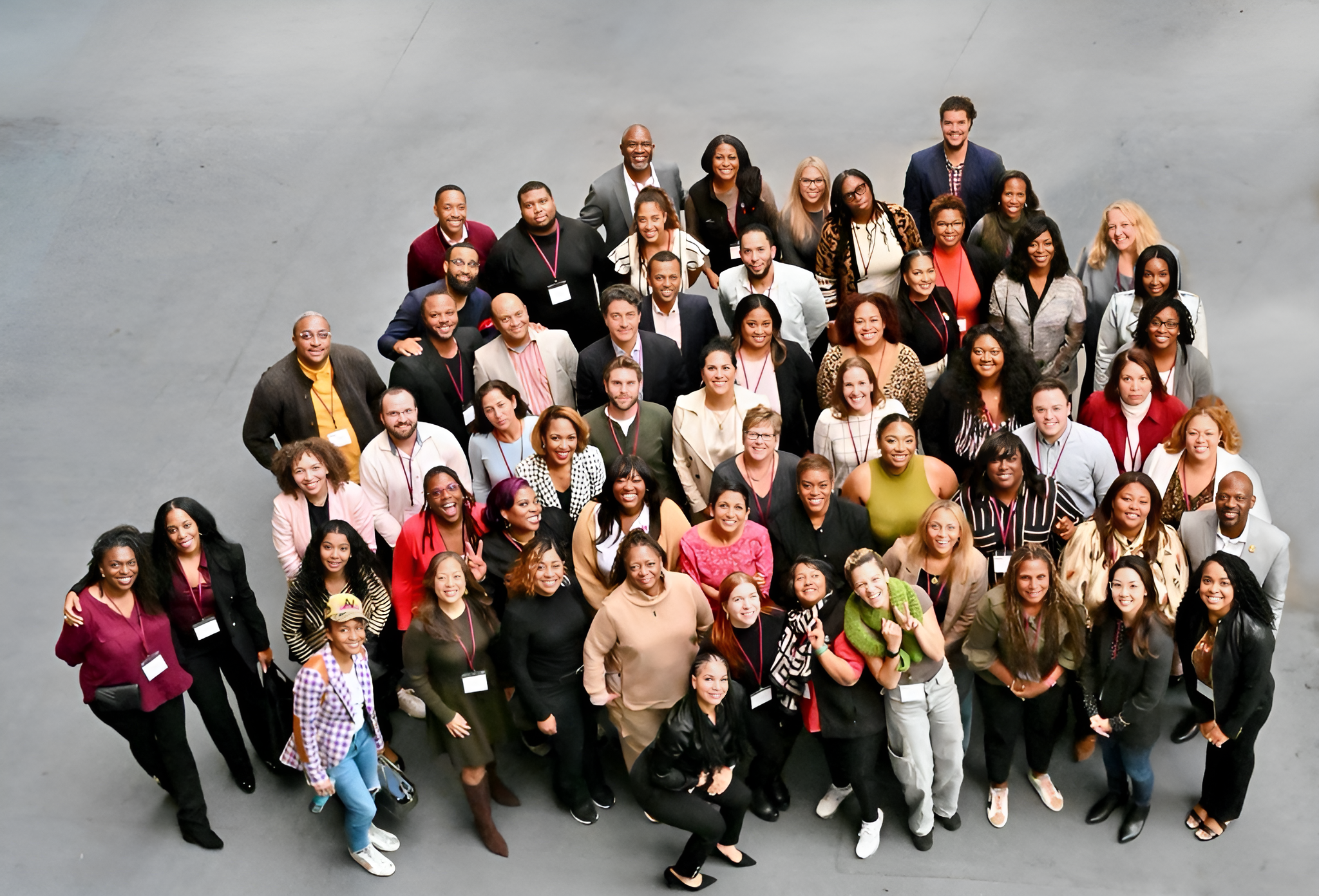 entire oneten team standing together looking up at the camera