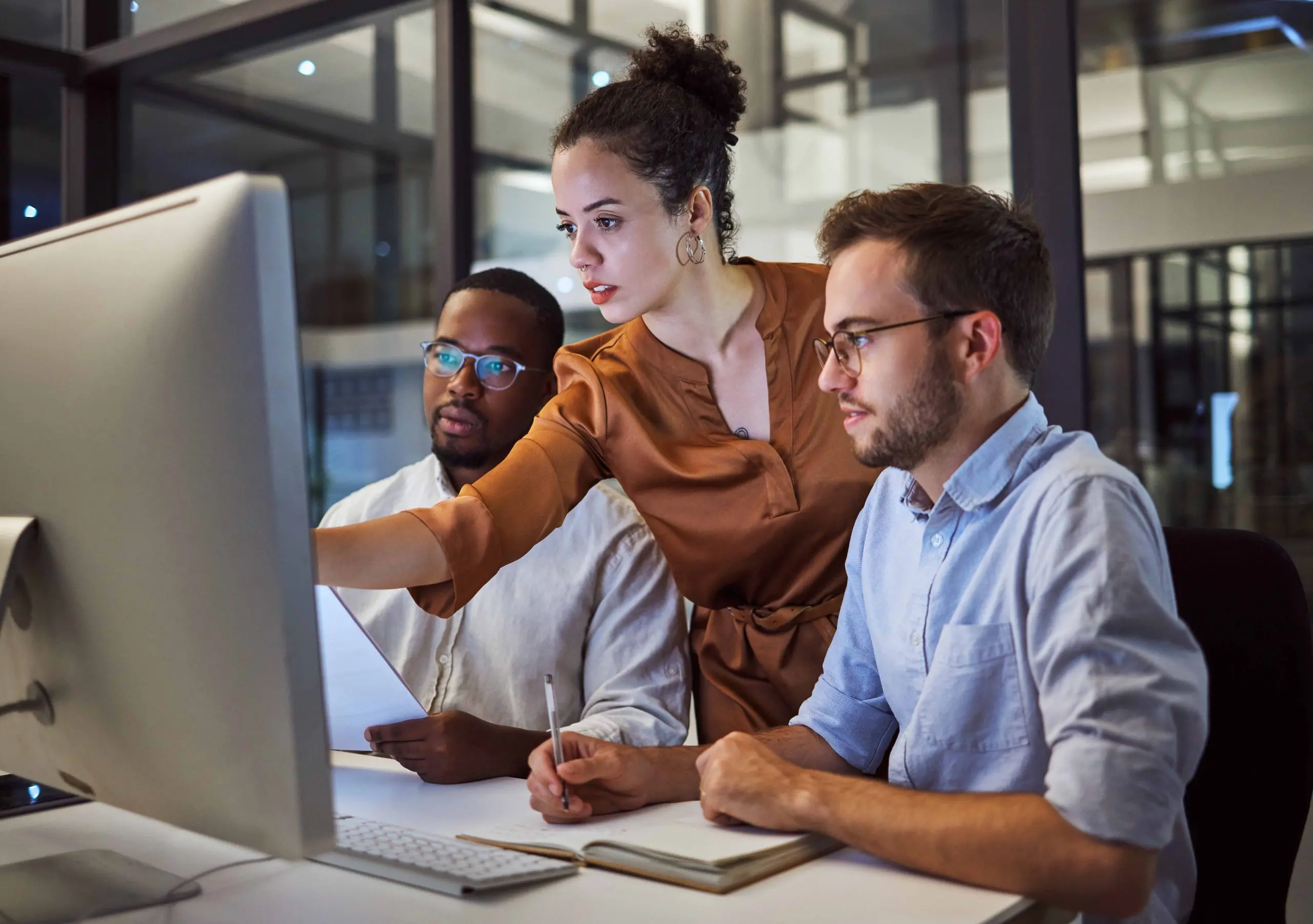 coworkers together at a computer reviewing work